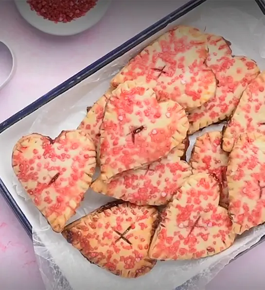 Types of strawberries in hand pies in a tray.