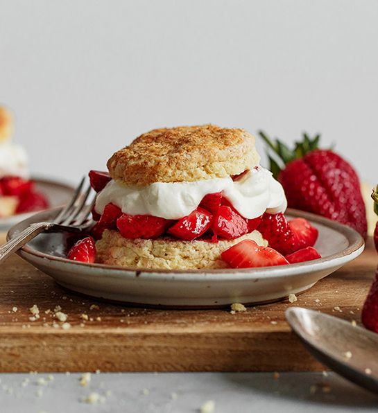 Types of strawberries in a shortcake with whipped cream.