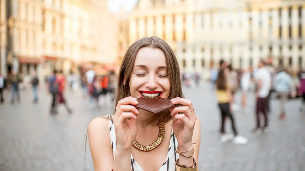 Woman with chocolate outdoors in Brussels