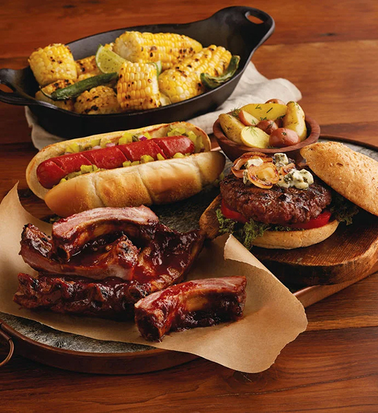 The father-in-law offers an array of ribs, sausage and roasted corn.