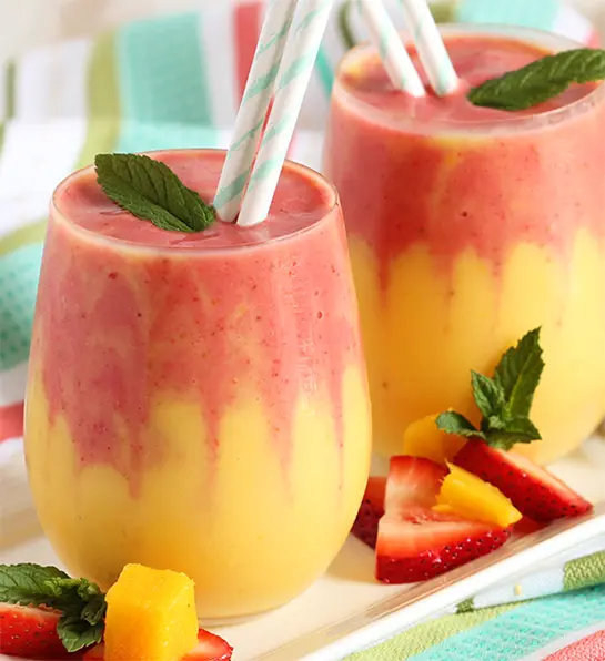 Mango strawberry smoothie in two glasses.
