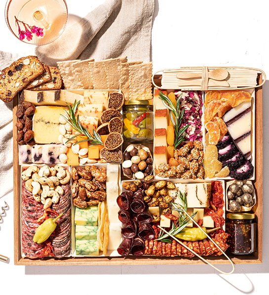 Boarderie charcuterie crate of cheese, meat, nuts, and other snacks.