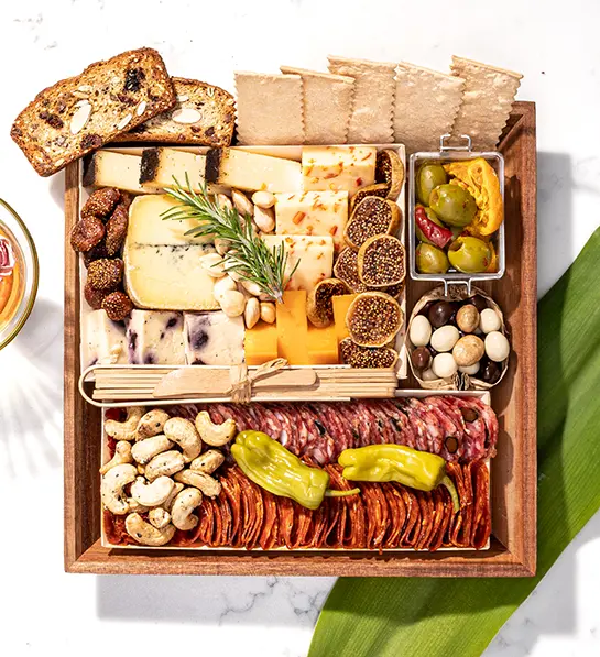 Boarderie charcuterie crate full of cheese, meat, crackers, and other snacks.