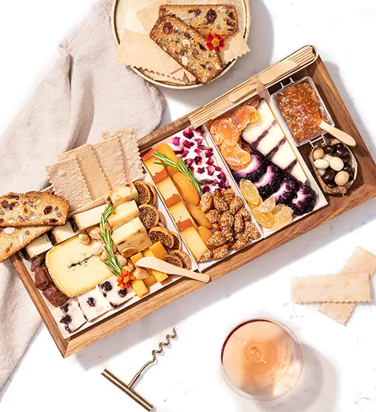 Boarderie charcuterie board with cheese, crackers, and nuts.