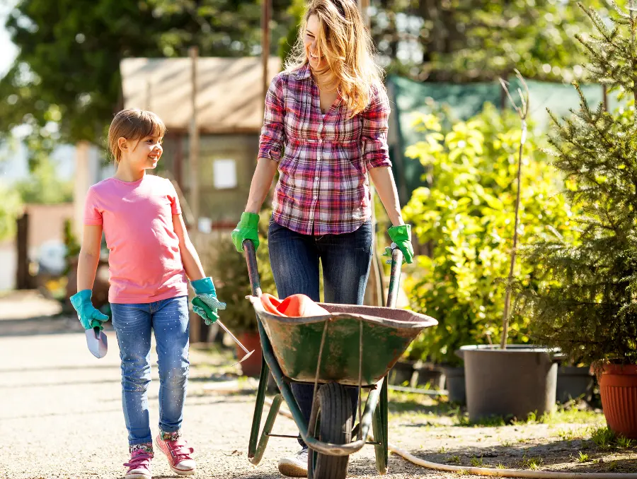 Health benefits of gardening with a mother and daughter gardening outside.