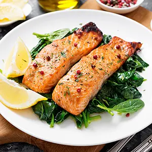 Summer squash seafood pairings with salmon on an plate with spinach.