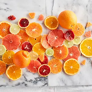 Slices of oranges on a marble counter top.