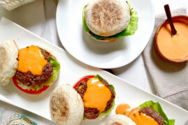 Gourmet burgers with Wolferman's English muffins on a serving tray.