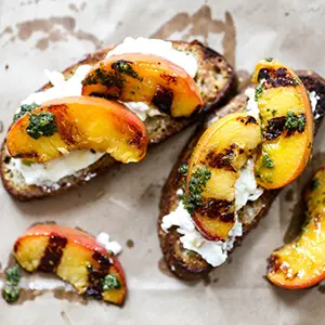 Peach recipes with several grilled peaches on crostini.