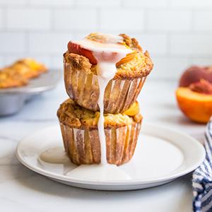 Peach recipes with two peach muffins on a plate.