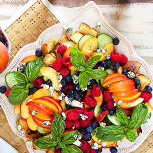 Peach recipes with a peach panzanella on a plate.