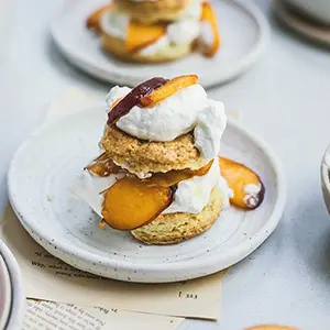 Peach recipes with a plate of peach shortcakes with cream.