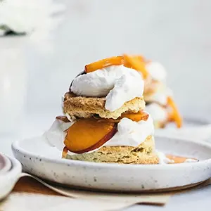 Peaches and cream shortcake on a plate.