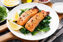 seafood and vegetable pairings with a plate of salmon on a bed of spinach.