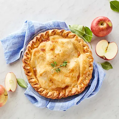 Types of pies with an apple pie surrounded by fruit.