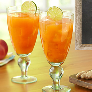 Two carrot juice cocktails on a table.