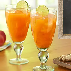 Two carrot juice cocktails on a table.