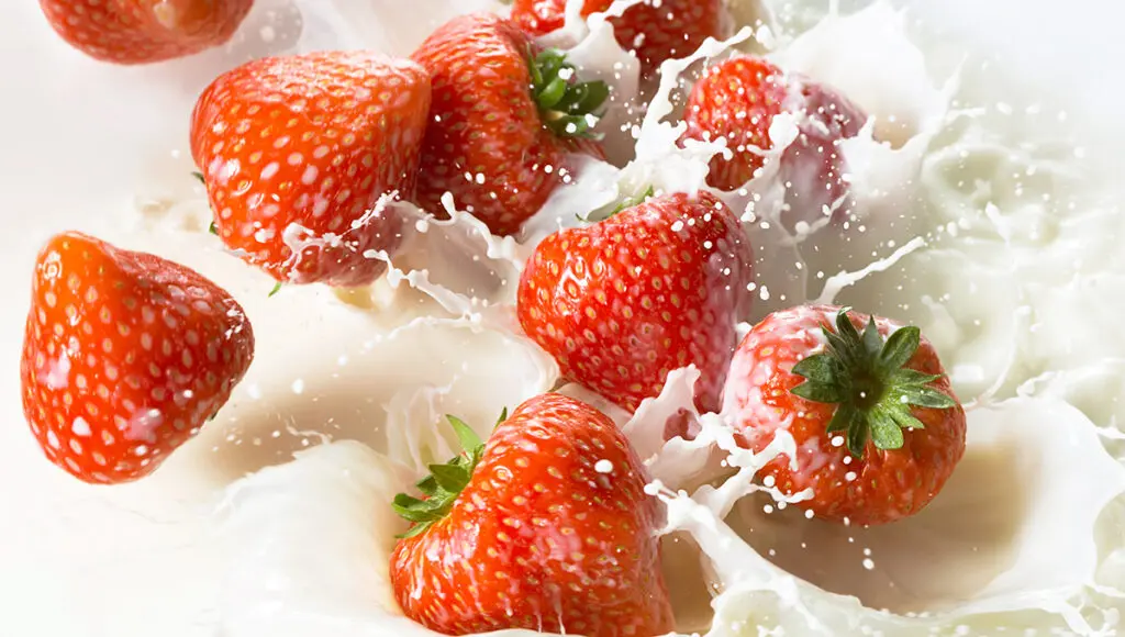 flavor pairings Red strawberries falling into milk
