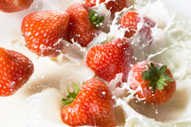 flavor pairings Red strawberries falling into milk
