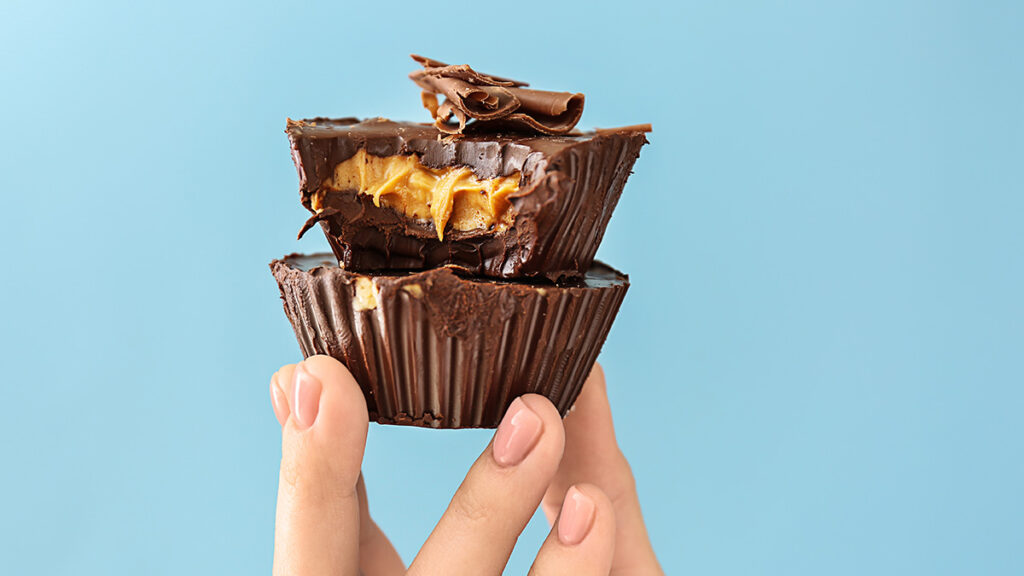 Flavor pairings with a hand holding up stacked chocolate peanut butter cups.