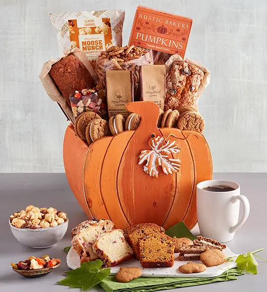 Fall gifts with a pumpkin shaped basket full of sweet treats and baked goods.