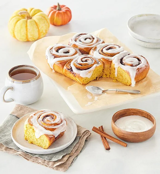 Fall gifts with a tray of pumpkin spice cinnamon rolls.