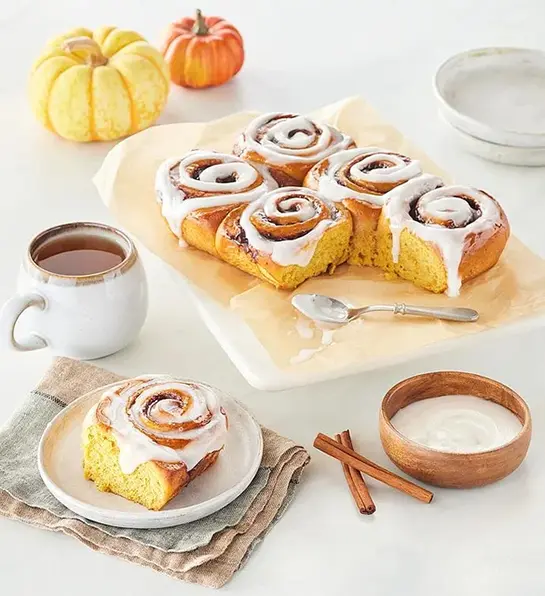Fall gifts with a tray of pumpkin spice cinnamon rolls.