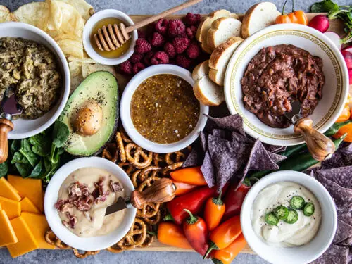 Game day recipes with a spread of dips and snacks.