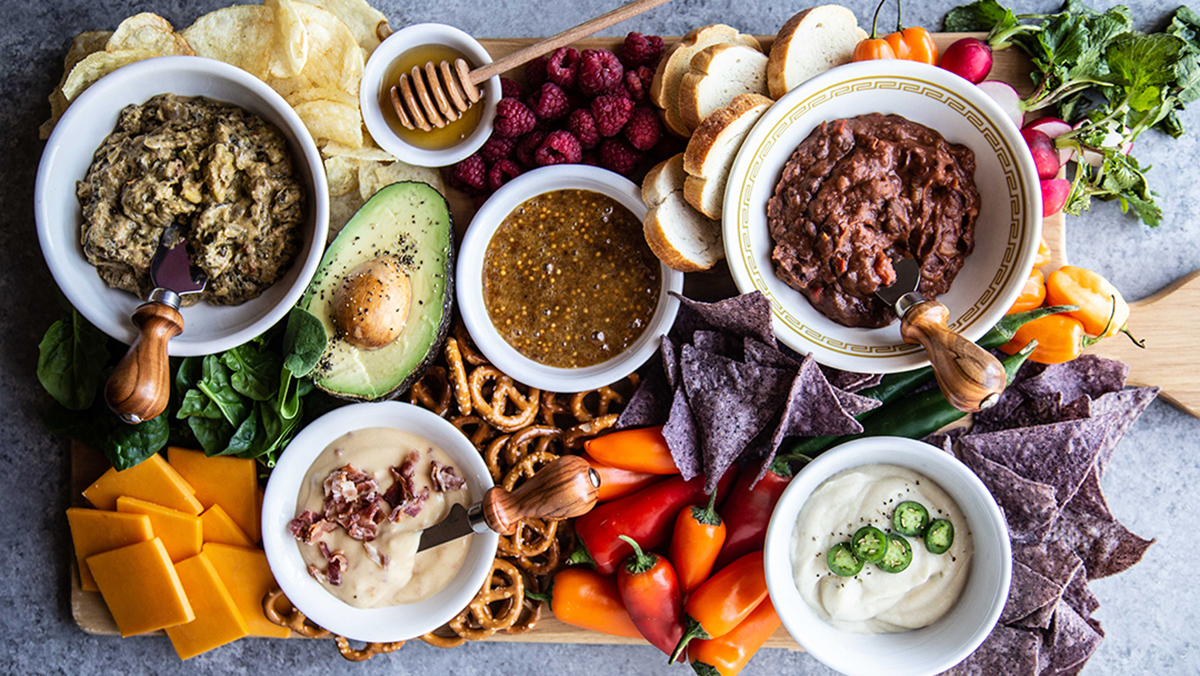 Game day recipes with a spread of dips and snacks.