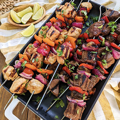 Game day recipes with a platter of chicken and vegetable kebabs.