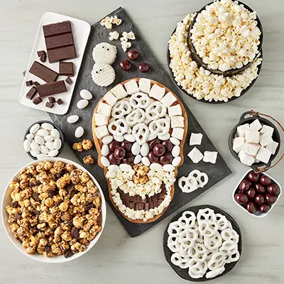 Halloween snack board with popcorn, candy, and more.