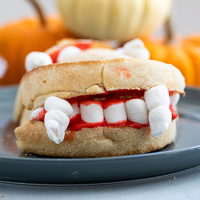 Halloween recipes with an English muffin and marshmallows designed to look like vampire fangs.