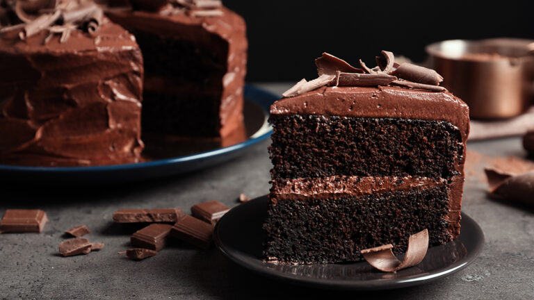 Types of cake with a slice of chocolate cake on a plate.