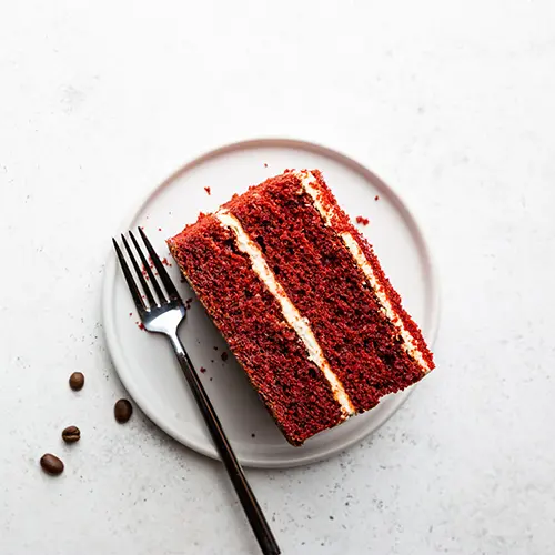 Slice of red velvet cake on a plate.