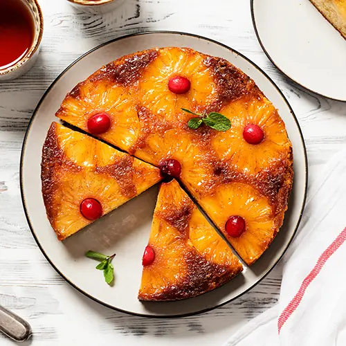 Homemade pineapple upside down pie with candied cranberry.