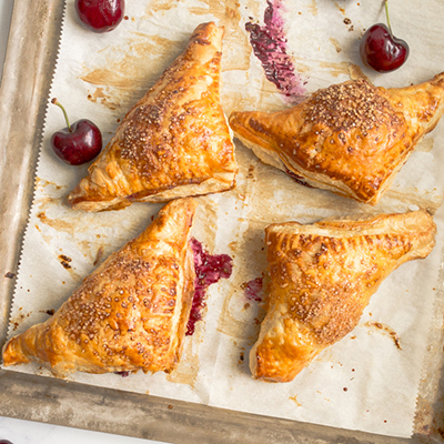 Types of pastries with a platter of cherry turnovers.