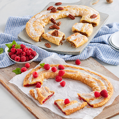 Types of pastries with two types of Kringle wreaths on platters.