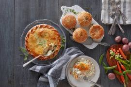Prepared meals deconstructed with chicken pot pies and ingredients on a counter.