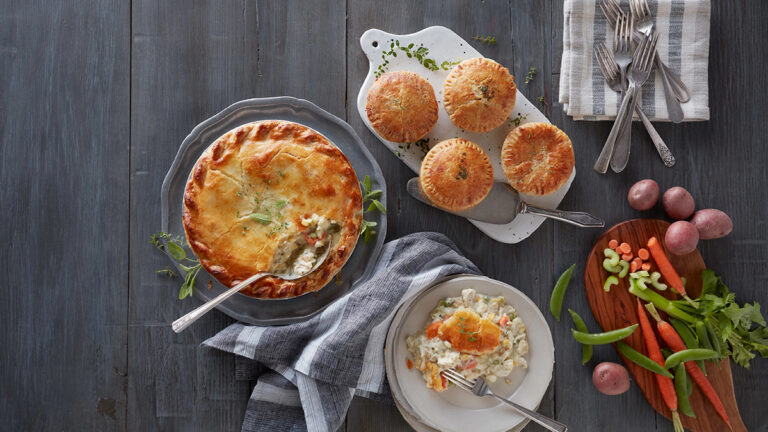 Prepared meals deconstructed with chicken pot pies and ingredients on a counter.