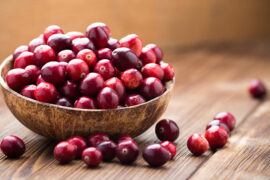 Cranberry facts with a bowl of cranberry.