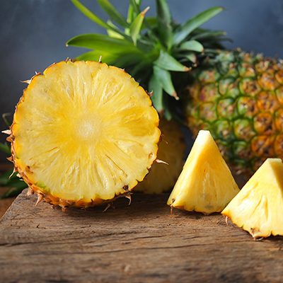 Ripe pineapple fruit cut in half and triangle shape.