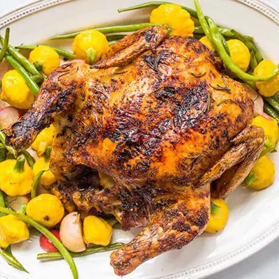 Roast chicken and vegetables on a plate for New Year's dinner.