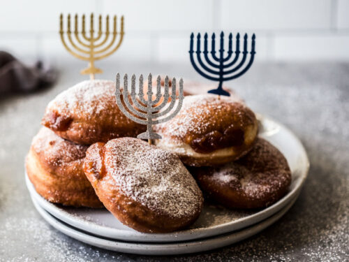 Sufganiyah recipe with several sufganiyah on a plate.