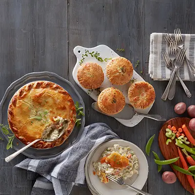 Winter wine pairings with multiple pot pies on a counter.