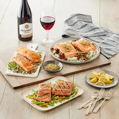 Winter wine pairings with plates of salmon and a bottle of pinot noir.