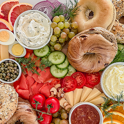 Spread of bagels, cream cheese, and other toppings.