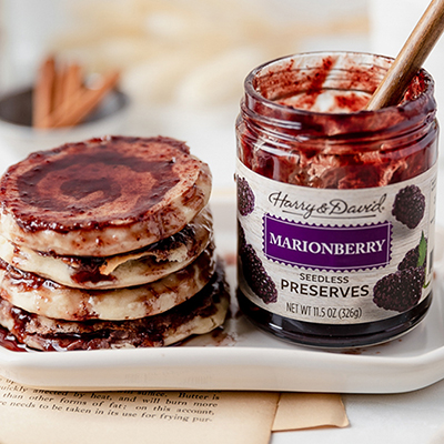 Breakfast for dinner with a plate of marionberry pancakes next to a jar of preserves.
