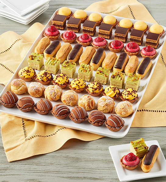Platter of mini cakes and truffles as dinner party ideas.