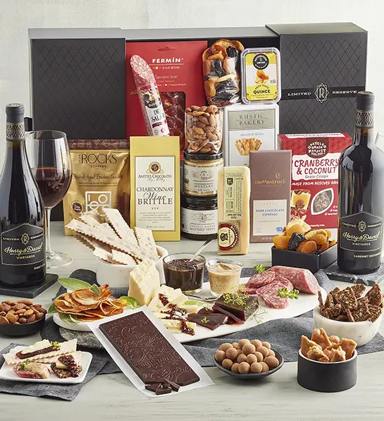 Box of sweet and savory snacks with two bottles of reserve wine.