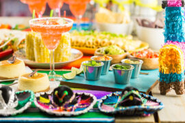 Cinco de Mayo party ideas with a table laid with food and a piñata